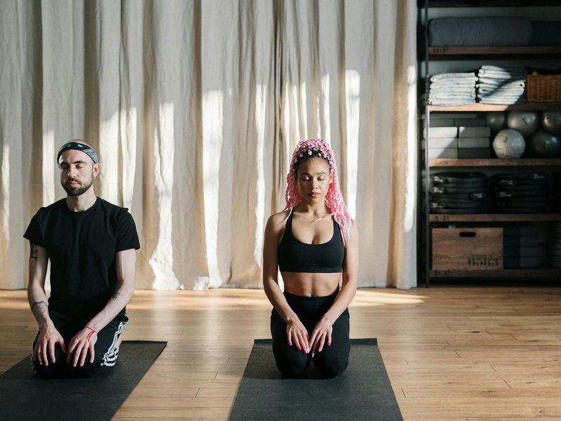 Person practicing yoga in a bright studio.